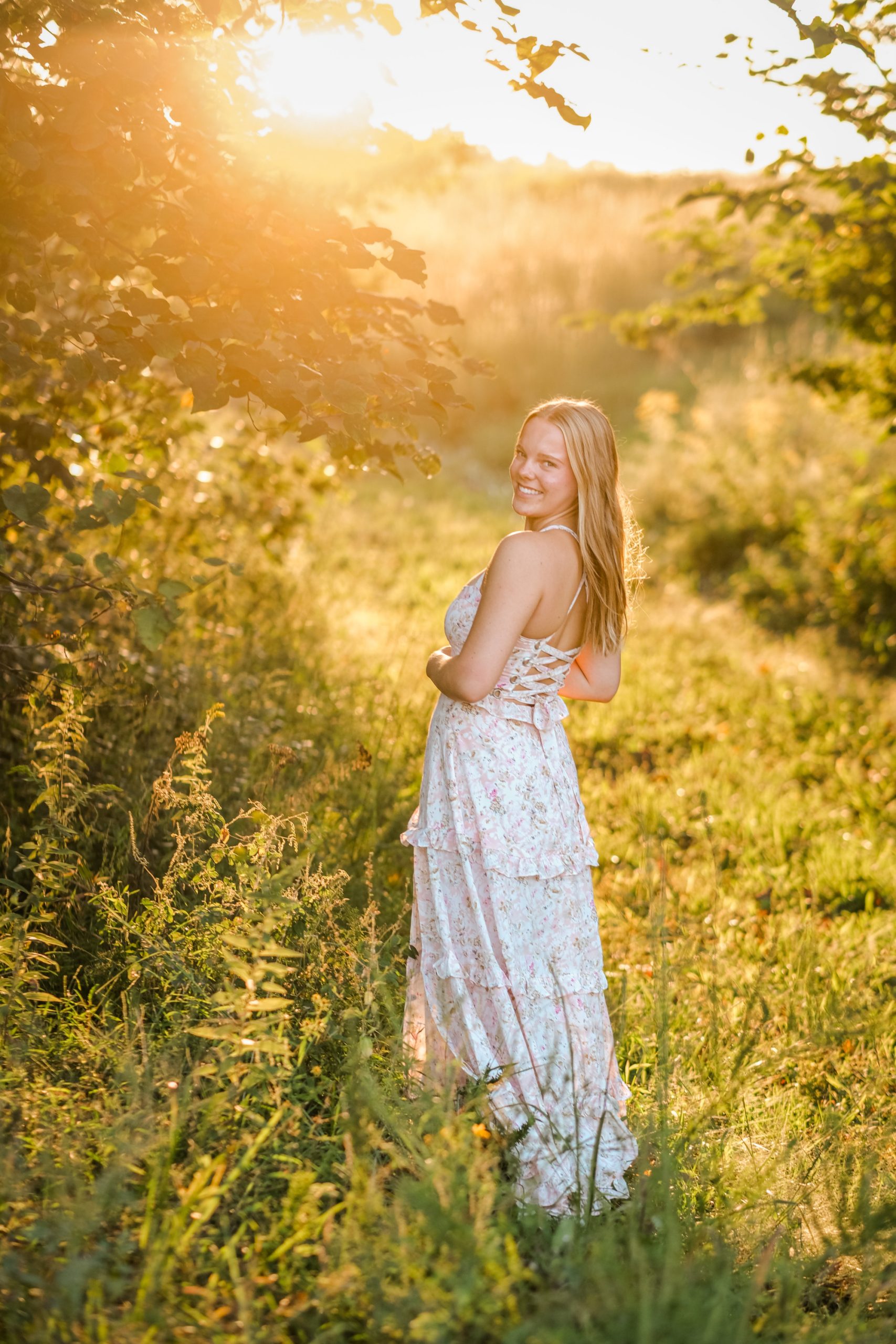 DelilaBruningSenior-38 Richmond Senior Photographer picture of girl at sunset in whimsical setting with tall grass and trees